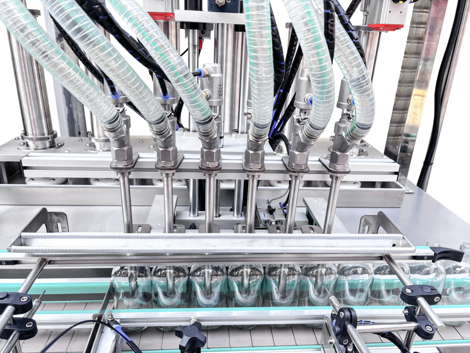 Bottle washing, piston filling, lower cap locking, and cap screwing line